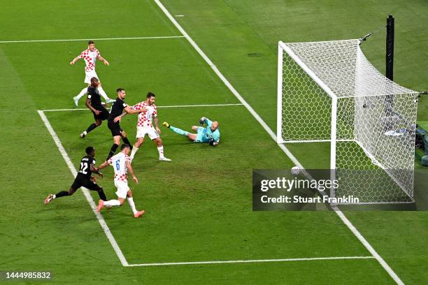 Andrej Kramaric of Croatia scores their team's first goal past Milan Borjan of Canada during the FIFA World Cup Qatar 2022 Group F match between...