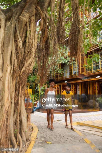mother and daughter walking around the city - playa del carmen stock pictures, royalty-free photos & images