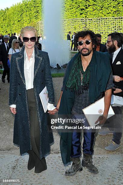 Tilda Swinton and fashion designer Haider Ackermann attend the Chanel 2012/13 Cruise Collection at Chateau de Versailles on May 14, 2012 in...
