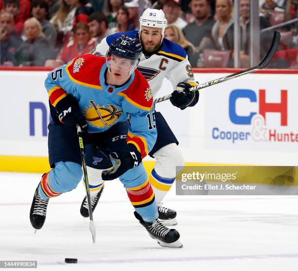 Anton Lundell of the Florida Panthers skates with the puck against Ryan O'Reilly of the St. Louis Blues at the FLA Live Arena on November 26, 2022 in...