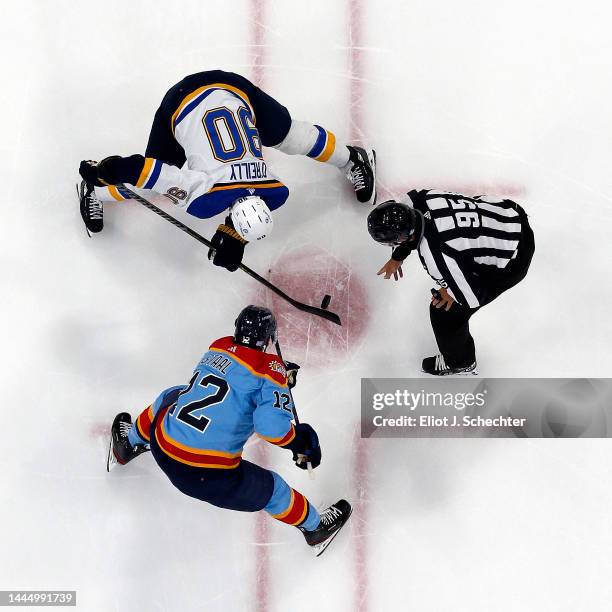 Linesmen Jonny Murray drops the puck for a face off between Ryan O'Reilly of the St. Louis Blues and Eric Staal of the Florida Panthers at the FLA...