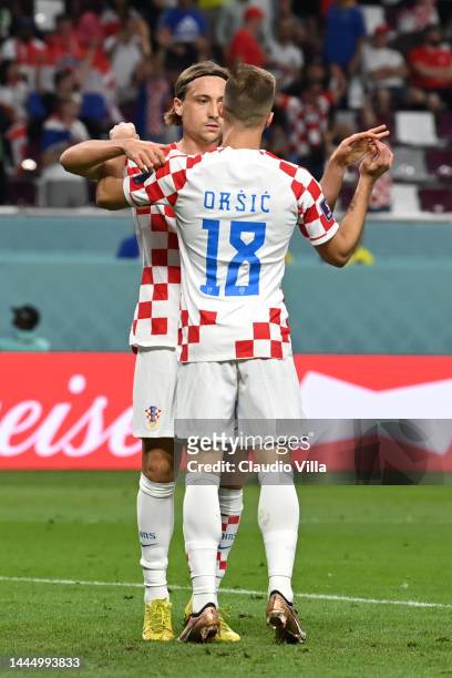 Lovro Majer of Croatia celebrates with Mislav Orsic after scoring their team's fourth goal during the FIFA World Cup Qatar 2022 Group F match between...