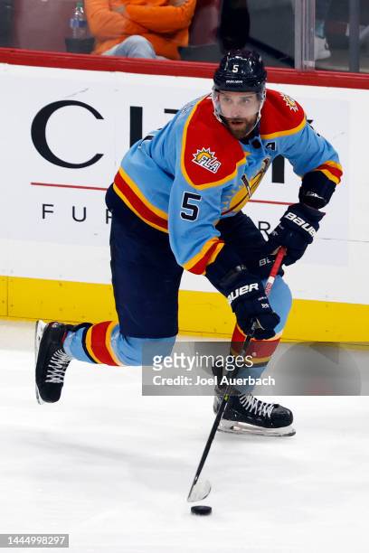 Aaron Ekblad of the Florida Panthers skates with the puck against the St Louis Blues at the FLA Live Arena on November 26, 2022 in Sunrise, Florida.