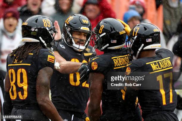 Brian Robinson Jr. #8 of the Washington Commanders celebrates after catching a touchdown pass in the first quarter of a game against the Atlanta...