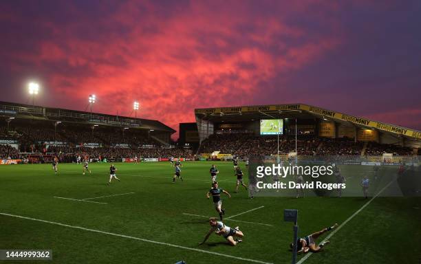 Ollie Hassell-Collins of London Irish scores a try as the sun sets during the Gallagher Premiership Rugby match between Leicester Tigers and London...