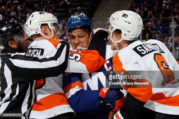 Anders Lee of the New York Islanders goes up against Rasmus Ristolainen and Travis Sanheim of the Philadelphia Flyers during the second period at the...