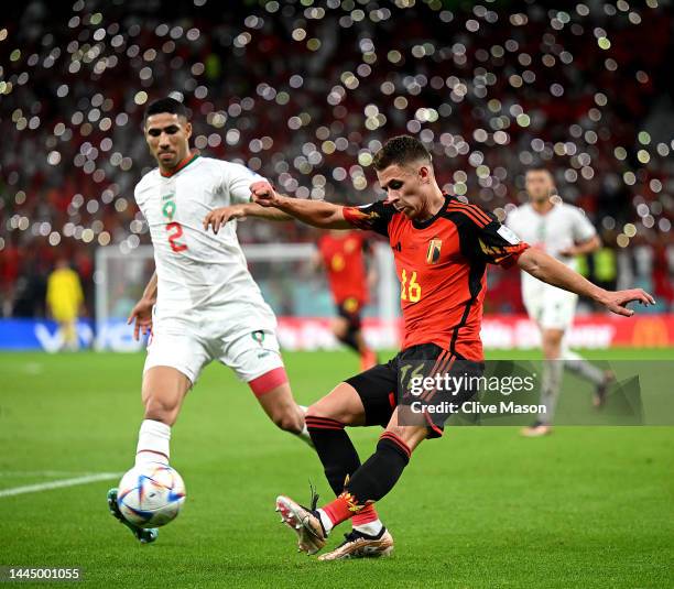 Thorgan Hazard of Belgium is challenged by Achraf Hakimi of Morocco during the FIFA World Cup Qatar 2022 Group F match between Belgium and Morocco at...