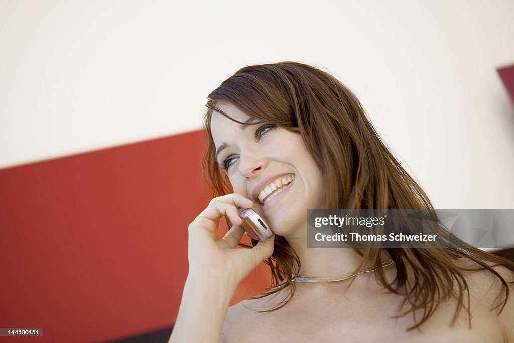 A woman laughing on a cell phone