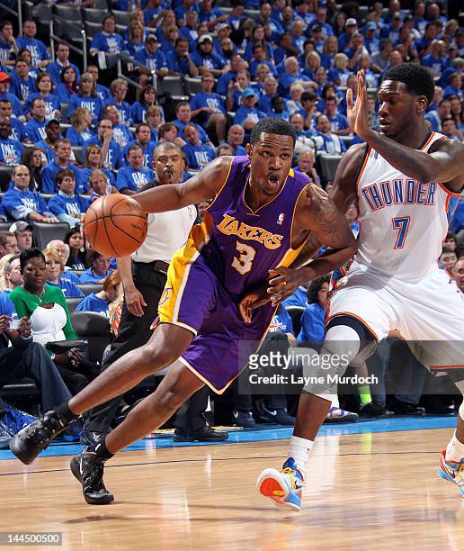 Devin Ebanks of the Los Angeles Lakers drives against Royal Ivey of the Oklahoma City Thunder during the Game One of the Western Conference...