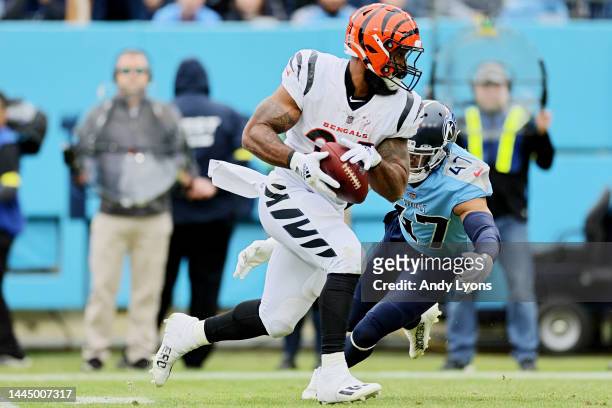 Samaje Perine of the Cincinnati Bengals runs with the ball as Andrew Adams of the Tennessee Titans defends during the first half at Nissan Stadium on...
