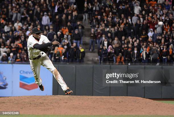 Joaquin Arias of the San Francisco Giants charges the ball and throws out Chris Nelson of the Colorado Rockies in the ninth inning for the final out...