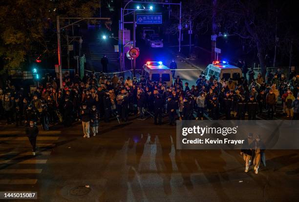 Protesters and police gather during a protest against Chinas strict zero COVID measures on November 27, 2022 in Beijing, China. Protesters took to...