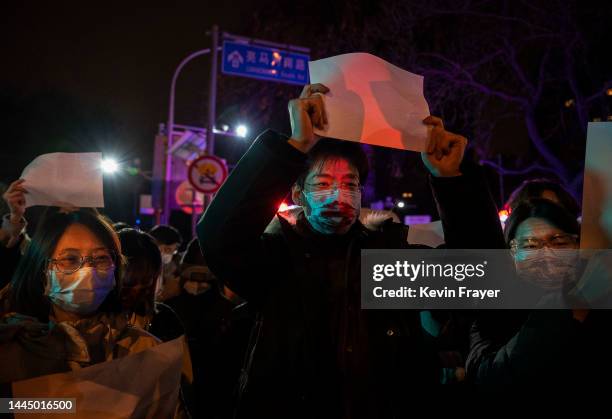 Protesters hold up a white piece of paper against censorship during a protest against Chinas strict zero COVID measures on November 27, 2022 in...