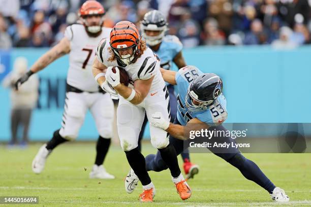 Hayden Hurst of the Cincinnati Bengals is tackled by Dylan Cole of the Tennessee Titans during the second half at Nissan Stadium on November 27, 2022...