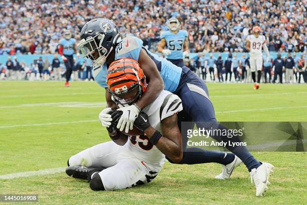 Tee Higgins of the Cincinnati Bengals catches the ball for a touchdown as Roger McCreary of the Tennessee Titans defends during the fourth quarter at...