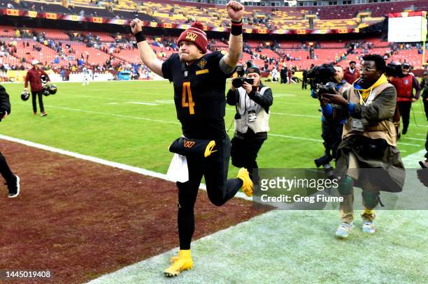Taylor Heinicke of the Washington Commanders celebrates after the Commanders beat the Atlanta Falcons 19-13 at FedExField on November 27, 2022 in...