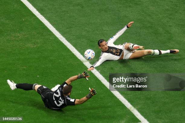 Unai Simon of Spain defends Leroy Sane of Germany during the FIFA World Cup Qatar 2022 Group E match between Spain and Germany at Al Bayt Stadium on...