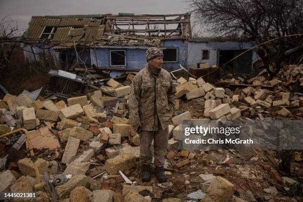 Anatoly Sikoza who buried the bodies stands amid the rubble of a house where Russian forces killed seven men and one woman, hands bound, blindfolded...