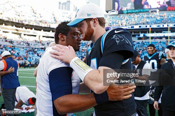 Russell Wilson of the Denver Broncos and Sam Darnold of the Carolina Panthers talk after a game at Bank of America Stadium on November 27, 2022 in...