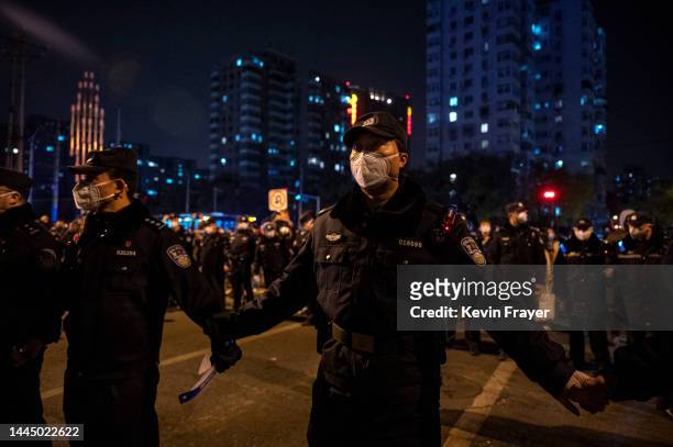 Police form a cordon during a protest against Chinas strict zero COVID measures on November 27, 2022 in Beijing, China. Protesters took to the...