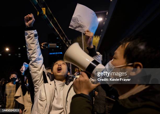 Protesters shout slogans during a protest against Chinas strict zero COVID measures on November 28, 2022 in Beijing, China. Protesters took to the...