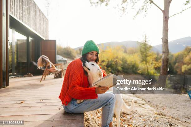little things that make my day - woman reading book dog stock pictures, royalty-free photos & images