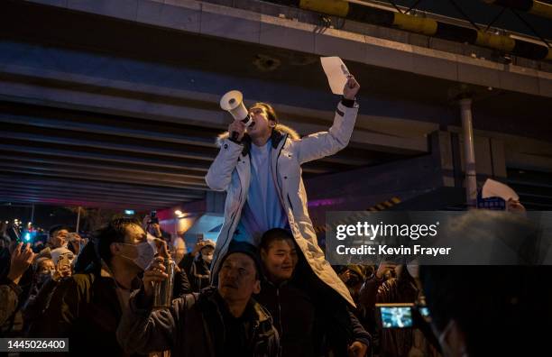 Protesters shout slogans during a protest against Chinas strict zero COVID measures on November 28, 2022 in Beijing, China. Protesters took to the...