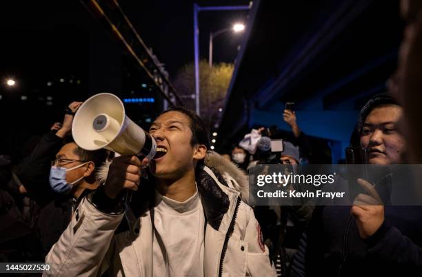 Protesters shouts slogans during a protest against Chinas strict zero COVID measures on November 28, 2022 in Beijing, China. Protesters took to the...