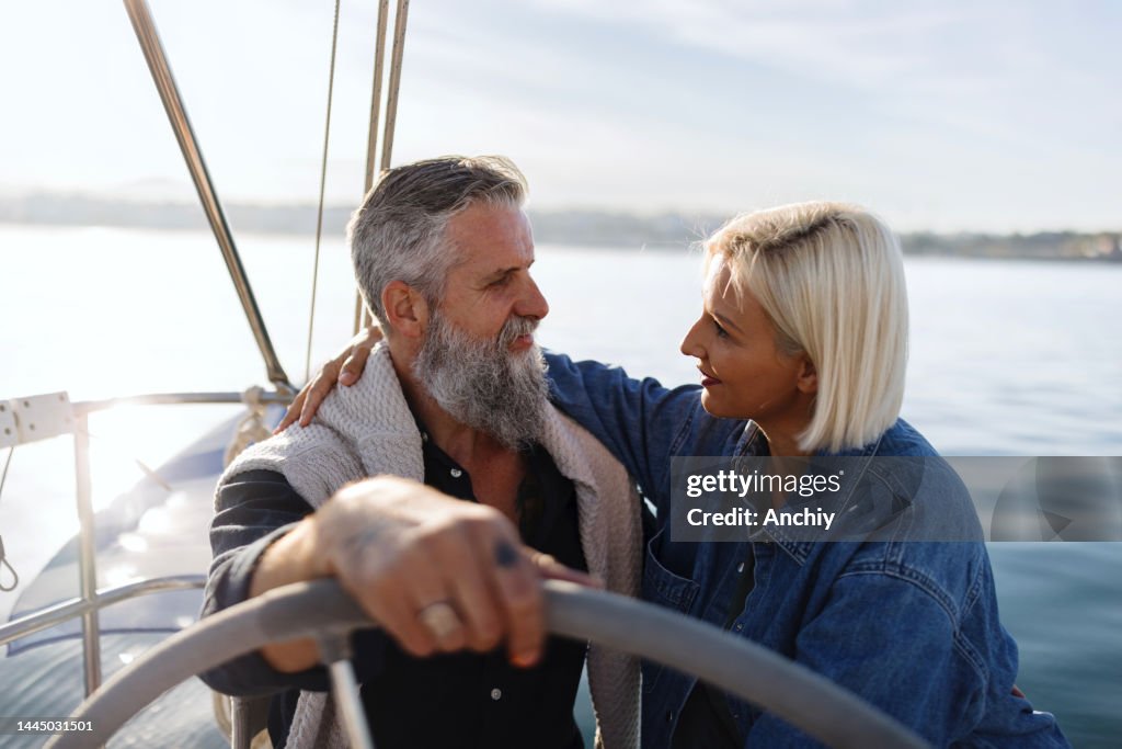 Couple enjoying their romantic vacation, sailing the sea