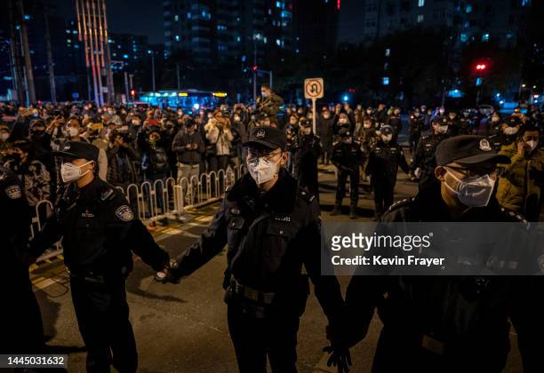 Police form a cordon during a protest against Chinas strict zero COVID measures on November 27, 2022 in Beijing, China. Protesters took to the...