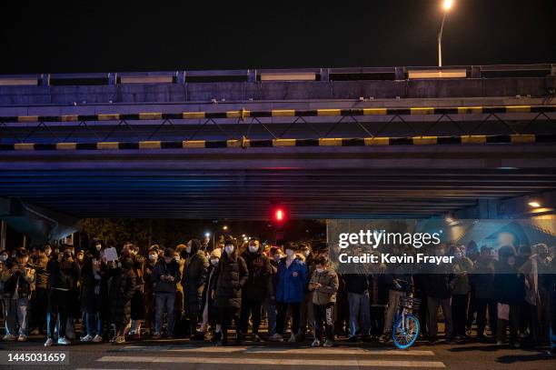 Protesters stand on the side of the road during a protest against Chinas strict zero COVID measures on November 27, 2022 in Beijing, China....