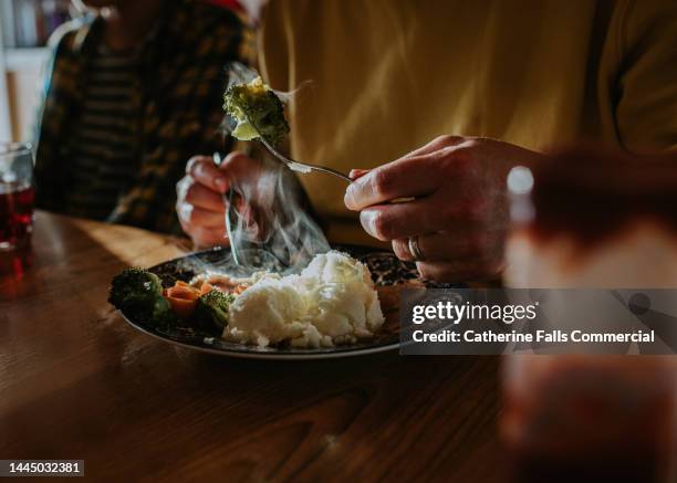 a man eats a sunday dinner with a knife and fork - eating chicken nuggets stock pictures, royalty-free photos & images