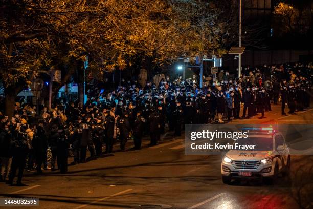 Protesters and police gather during a protest against Chinas strict zero COVID measures on November 28, 2022 in Beijing, China. Protesters took to...