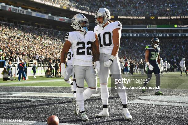 Ameer Abdullah of and Mack Hollins of the Las Vegas Raiders celebrate a touchdown during the first half in the game against the Seattle Seahawks at...
