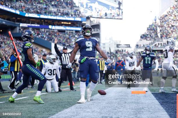 Kenneth Walker III of the Seattle Seahawks celebrate a touchdown during the first half in the game against the Las Vegas Raiders at Lumen Field on...