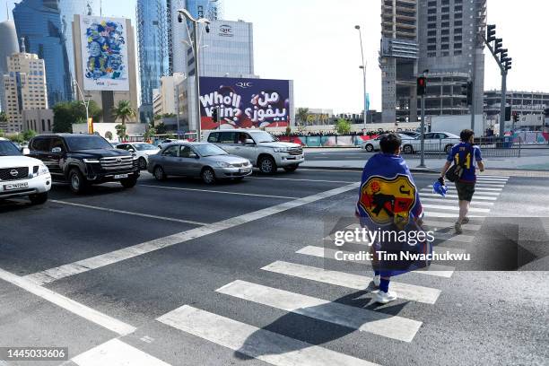 Japanese fans cross the street during the FIFA World Cup Qatar 2022 at on November 27, 2022 in Doha, Qatar.