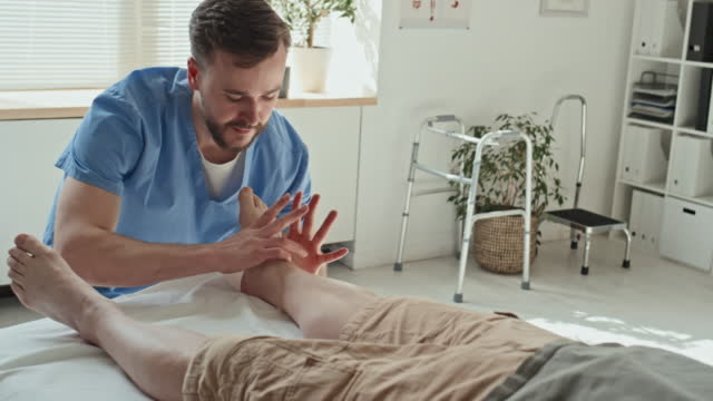 Doctor Doing Massage on Feet of Patient