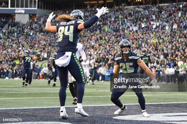 Dareke Young and Travis Homer of the Seattle Seahawks celebrate after Homer scored a touchdown in the fourth quarter against the Las Vegas Raiders at...
