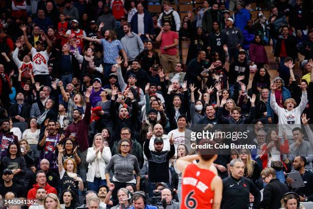 Raptors fans cheer during a giveaway in the second half of the NBA game between the Toronto Raptors and the Brooklyn Nets at Scotiabank Arena on...