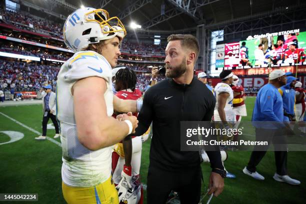 Justin Herbert of the Los Angeles Chargers and head coach Kliff Kingsbury of the Arizona Cardinals meet at midfield after the Chargers beat the...