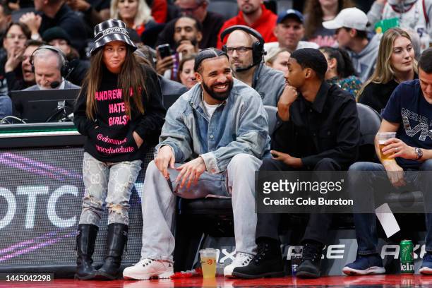 Rapper Drake smiles as he sits courtside with Future The Prince during the second half of the NBA game between the Toronto Raptors and the Brooklyn...