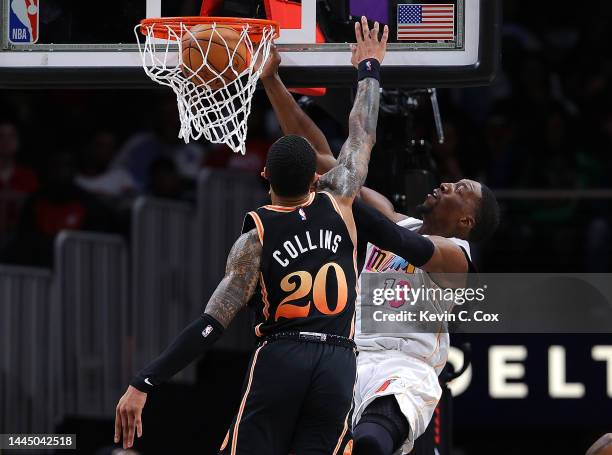 Bam Adebayo of the Miami Heat dunks against John Collins of the Atlanta Hawks during the second half at State Farm Arena on November 27, 2022 in...