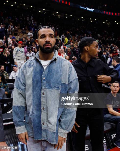 Rapper Drake waits for players at the end of the NBA game between the Toronto Raptors and the Brooklyn Nets at Scotiabank Arena on November 23, 2022...