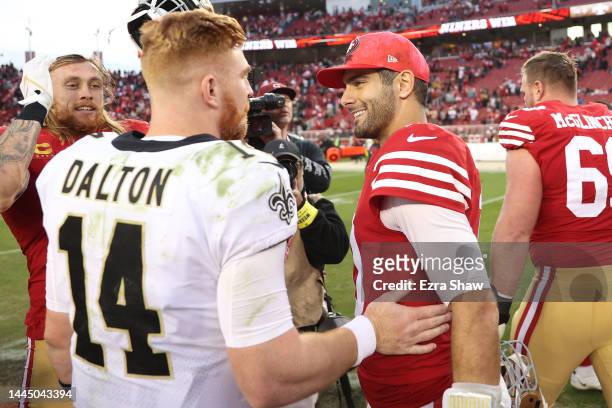 Jimmy Garoppolo of the San Francisco 49ers and Andy Dalton of the New Orleans Saints embrace after the game at Levi's Stadium on November 27, 2022 in...