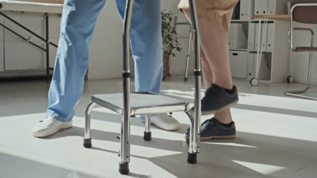Patient Exercising on Step Together with Doctor
