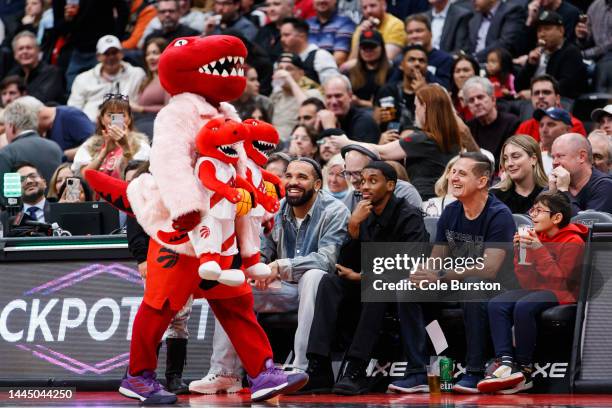 Rapper Drake smiles as he sits courtside with Future The Prince during the second half of the NBA game between the Toronto Raptors and the Brooklyn...