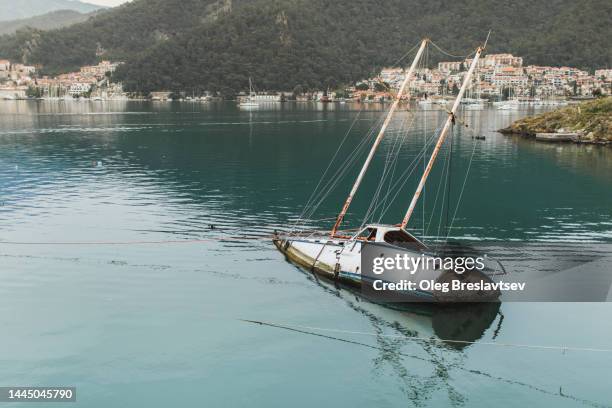 broken and forsaken yacht after storm. boat shipwreck - abandoned boat stock pictures, royalty-free photos & images