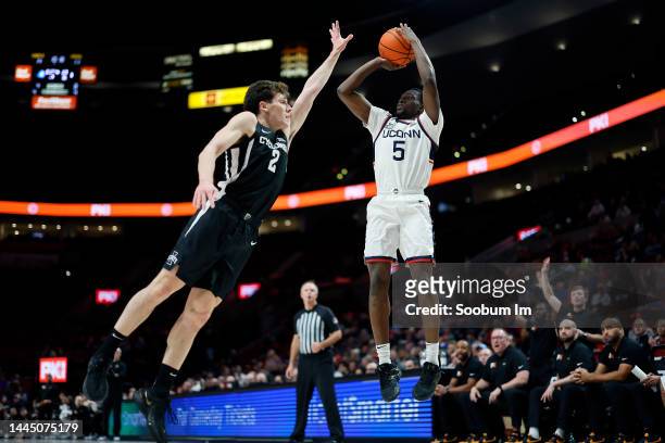 Hassan Diarra of the UConn Huskies shoots the ball over Caleb Grill of the Iowa State Cyclones during the first half of the Phil Knight Invitational...