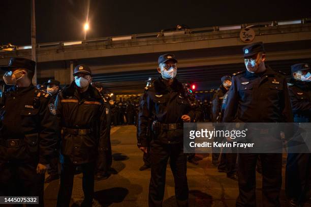 Police form a cordon during a protest against China's strict zero COVID measures on November 28, 2022 in Beijing, China. Protesters took to the...