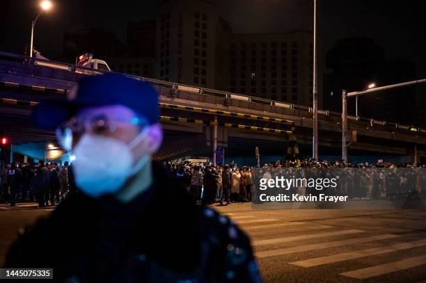 Police stand as part of a cordon during a protest against China's strict zero COVID measures on November 28, 2022 in Beijing, China. Protesters took...